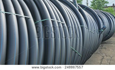 Warehouse Of Finished Plastic Pipes Industrial Outdoors Storage Site. Manufacture Of Plastic Water P