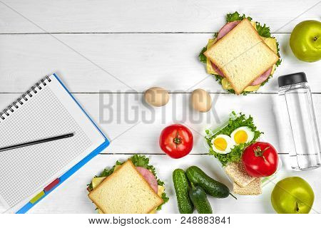 Top View Planning Notebook With Copy Space And Healthy Breakfast. Sandwich With Ham And Cheese, Eggs