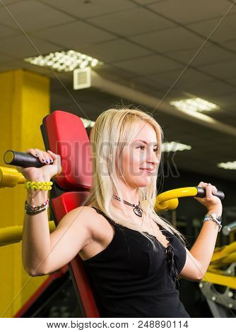 Sport, Fitness, Lifestyle And People Concept - Close Up Of Young Woman Flexing Muscles On Cable Gym 