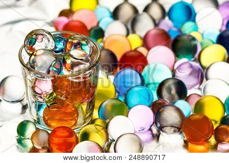 A Lot Of Hydrogel Balls On Aluminum Foil And A Vodka Pile Filled With Hydrogel Balls Of Different Co