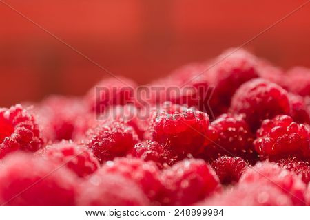 Background Texture Of Dripping Raspberry. Close-up Photo.