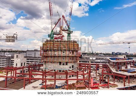 Construction Site With Cranes And Building With Blue Sky Background