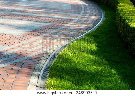 Pavement Tile With Drainage And Shorn Grass In Landscape Design