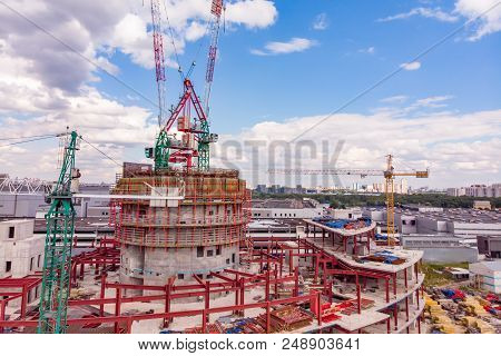 Construction Site With Cranes And Building With Blue Sky Background