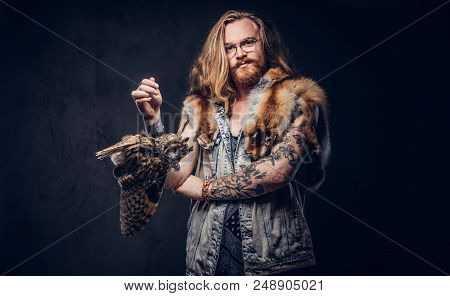 Portrait Of A Tattoed Redhead Hipster Male With Long Luxuriant Hair And Full Beard Dressed In A T-sh