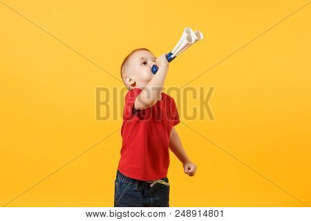 Little Cute Kid Baby Boy 3-4 Years Old, Football Fan In Red T-shirt Holding In Hand Pipe, Blowing Is