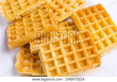 Close-up Of Homemade Fresh Brown Waffles.
View To Stacked Wafles On A White Plate.
Bakery And Food B