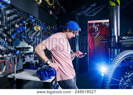 A Young, Stylish Redheaded Male Small Business Owner Selling And Repairing A Bike Is Wearing A Blue 