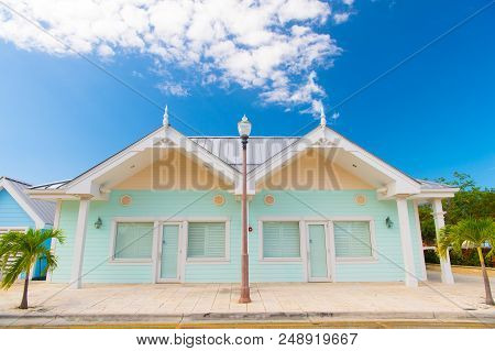 Book Now Pay Later. Houses Little Cute Apartments Tropic Island With Palm Trees On Sunny Summer Day.