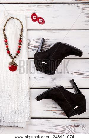 Pair Of Black Suede Heel Boots. Woolean Sweater, Necklace With Ruby. Talisman Earrings.