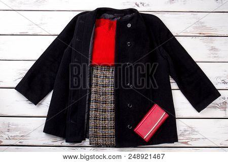 Set Of Stylish Winter Clothes Concept. Black Cashmere Coat, Pants, Red Sweater And Wallet. Bright Be