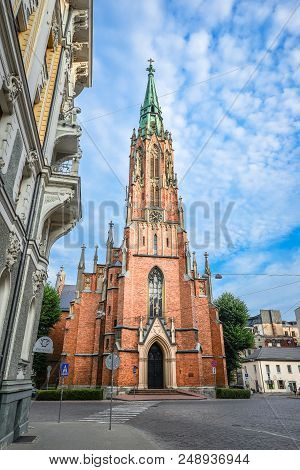 Riga, Latvia - August 22, 2017: View On Ancient Saint Gertrude Old Church And Bright Blue Sky, Riga 