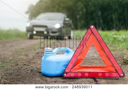Gasoline Has Reached A Limit Concept. Not Enough Fuel. Red Emergency Triangle Stop Sign, Empty Canis
