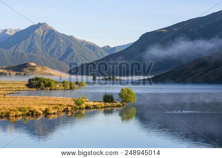 Lake Grasmere, Canterbury, New Zealand, In Early Morning Light, With The Southern Alps As A Backdrop