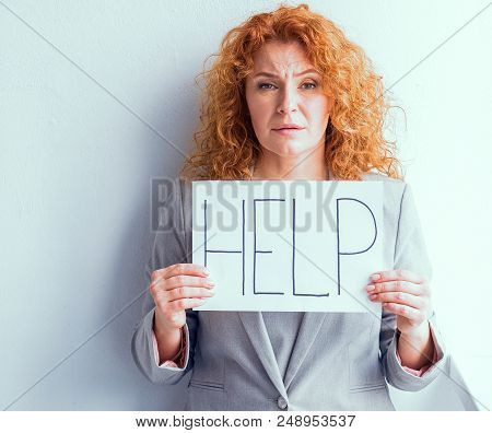 Dissapointed Mid Aged Business Woman Holding Poster With Word Help. Stressed Tired Woman Needs Askin