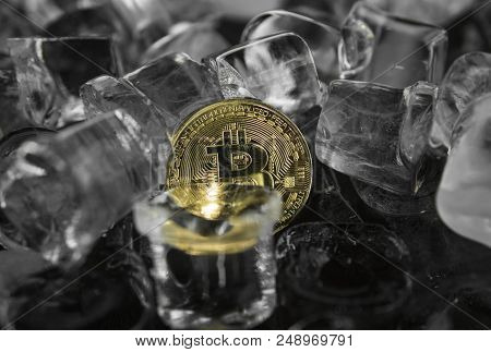 Gold Bitcoin On Ice Background. The Concept Of The Exchange In Winter. Freeze. Blockchain Mining. Di