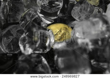 Gold Bitcoin On Ice Background. The Concept Of The Exchange In Winter. Freeze. Blockchain Mining. Di