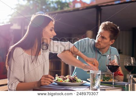 Greedy Man. Greedy Angry Man Feeling Furious While Not Letting His Woman Trying His Salad