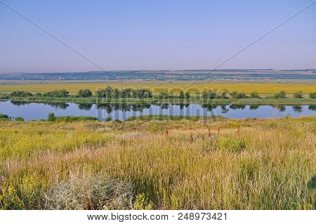 Transparent River Surface Against The Backdrop Of Picturesque Green Nature