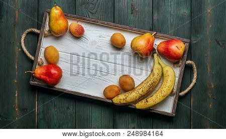 Fresh Authentic Fruit On A White Wooden Tray: Banatas, Pears, Apricots. Countryside Setting. Top Vie