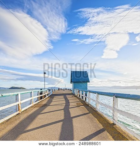 Old Jetty At Petone, Wellington, New Zealand Under A Dramatic Sunny Sky.