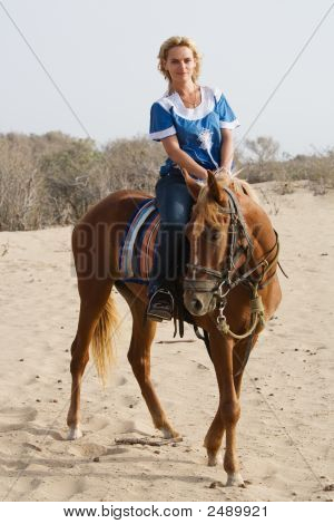 Girl Riding On The Beach