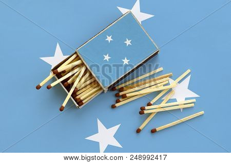 Micronesia Flag  Is Shown On An Open Matchbox, From Which Several Matches Fall And Lies On A Large F