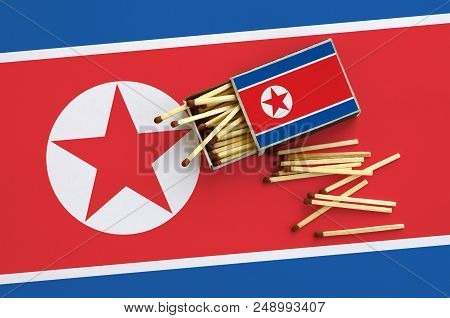 North Korea Flag  Is Shown On An Open Matchbox, From Which Several Matches Fall And Lies On A Large 