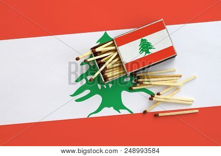 Lebanon Flag  Is Shown On An Open Matchbox, From Which Several Matches Fall And Lies On A Large Flag