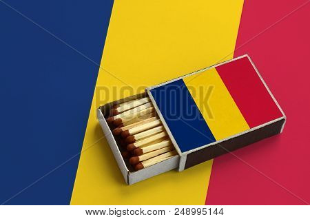 Chad Flag  Is Shown In An Open Matchbox, Which Is Filled With Matches And Lies On A Large Flag.