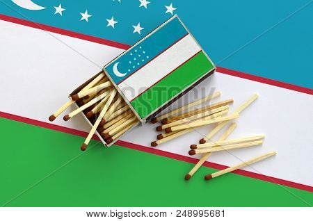 Uzbekistan Flag  Is Shown On An Open Matchbox, From Which Several Matches Fall And Lies On A Large F