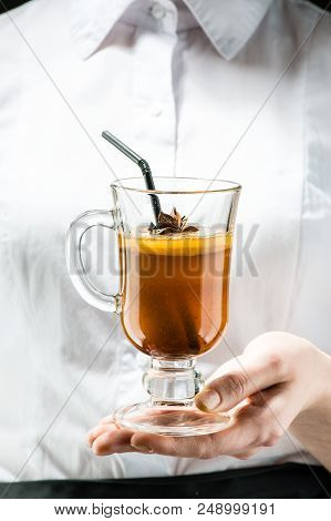 The Unidentified Waiter Holding A Glass With Hot Buttered Becherovka Cocktail