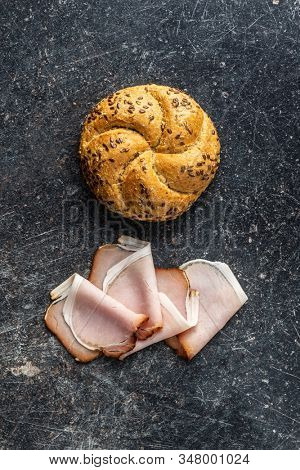 Sliced smoked ham. Tasty pork meat and bun. Top view.