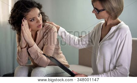 Anxious Young Female Patient Looking With Hope At Psychotherapist, Real Help