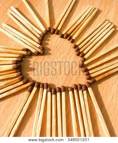 Wooden Safety Matches On A Wooden Background Arranged In The Shape Of A Heart. Matchsticks In The Sh
