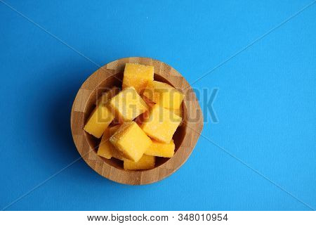 Wooden Bowl Of Mango Succades Isolated On Blue Background Flat Lay. Image Contains Copy Space