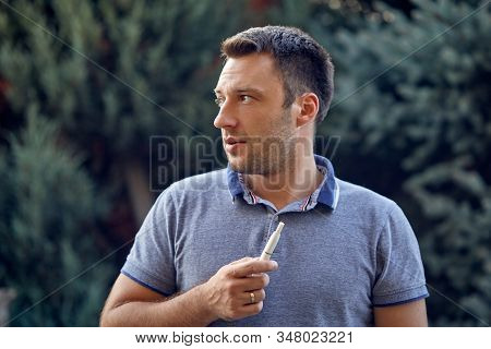 Electronic Cigarettes, Cigarette Technology. Tobacco Iqos System. Close-up Of A Man Smoking An Elect