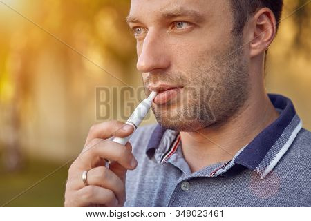 Electronic Cigarettes, Cigarette Technology. Tobacco Iqos System. Close-up Of A Man Smoking An Elect