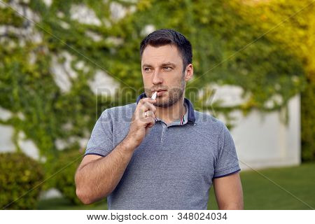 Electronic Cigarettes, Cigarette Technology. Tobacco Iqos System. Close-up Of A Man Smoking An Elect