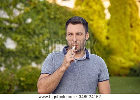 Electronic Cigarettes, Cigarette Technology. Tobacco Iqos System. Close-up Of A Man Smoking An Elect