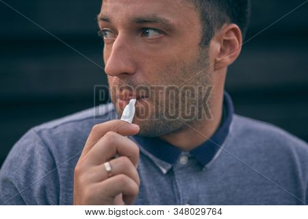 Electronic Cigarettes, Cigarette Technology. Tobacco Iqos System. Close-up Of A Man Smoking An Elect