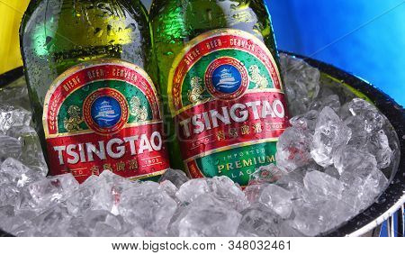 Two Bottles Of Tsingtao Beer In Bucket With Crushed Ice