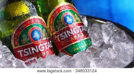 Two Bottles Of Tsingtao Beer In Bucket With Crushed Ice