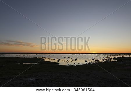 Beautiful Sunset Over An Arctic Landscape With Rocks In The Foreground.  Taken North Of Arviat, Nuna