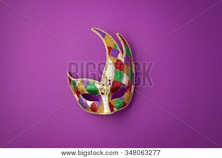 Festive, Colorful Mardi Gras Or Carnivale Mask And Accessories Over Purple Background. Party Invitat