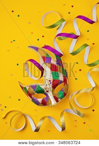 Festive, Colorful Mardi Gras Or Carnivale Mask And Accessories Over Yellow Background. Party Invitat