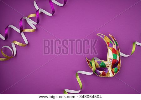 Festive, Colorful Mardi Gras Or Carnivale Mask And Accessories Over Purple Background. Party Invitat