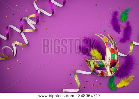 Festive, Colorful Mardi Gras Or Carnivale Mask And Accessories Over Purple Background. Party Invitat