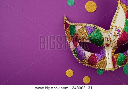 Festive, Colorful Mardi Gras Or Carnivale Mask And Accessories Over Purple Background. Party Invitat
