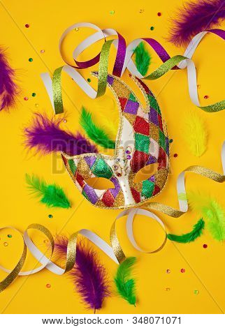 Festive, Colorful Mardi Gras Or Carnivale Mask And Accessories Over Yellow Background. Party Invitat
